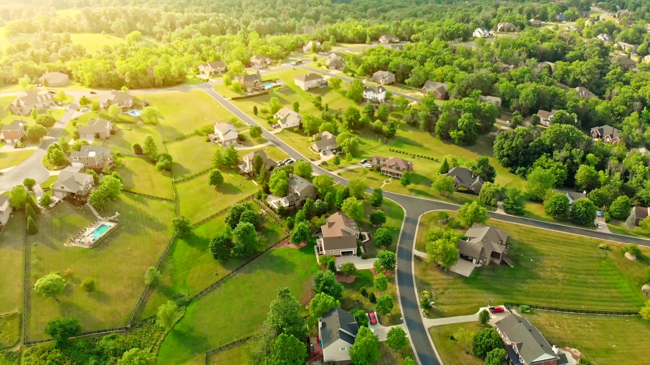 Aerial view of a Kentucky suburban neighborhood with houses, roads, and green yards
