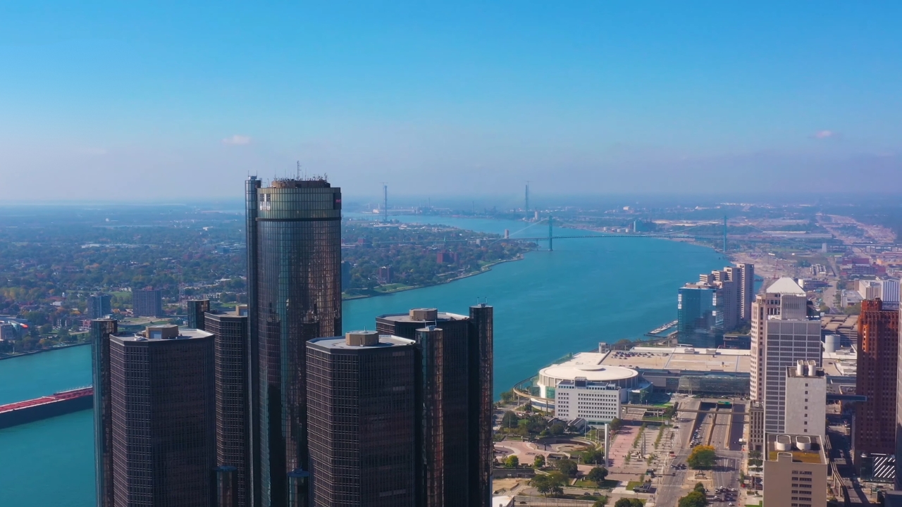 Aerial view of Detroit skyline with high-rise buildings along the river and surrounding city area