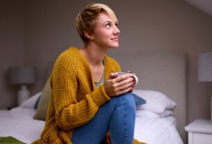 A single renter sits in a one-bedroom apartment and thinks about rent affordability in major U.S. cities