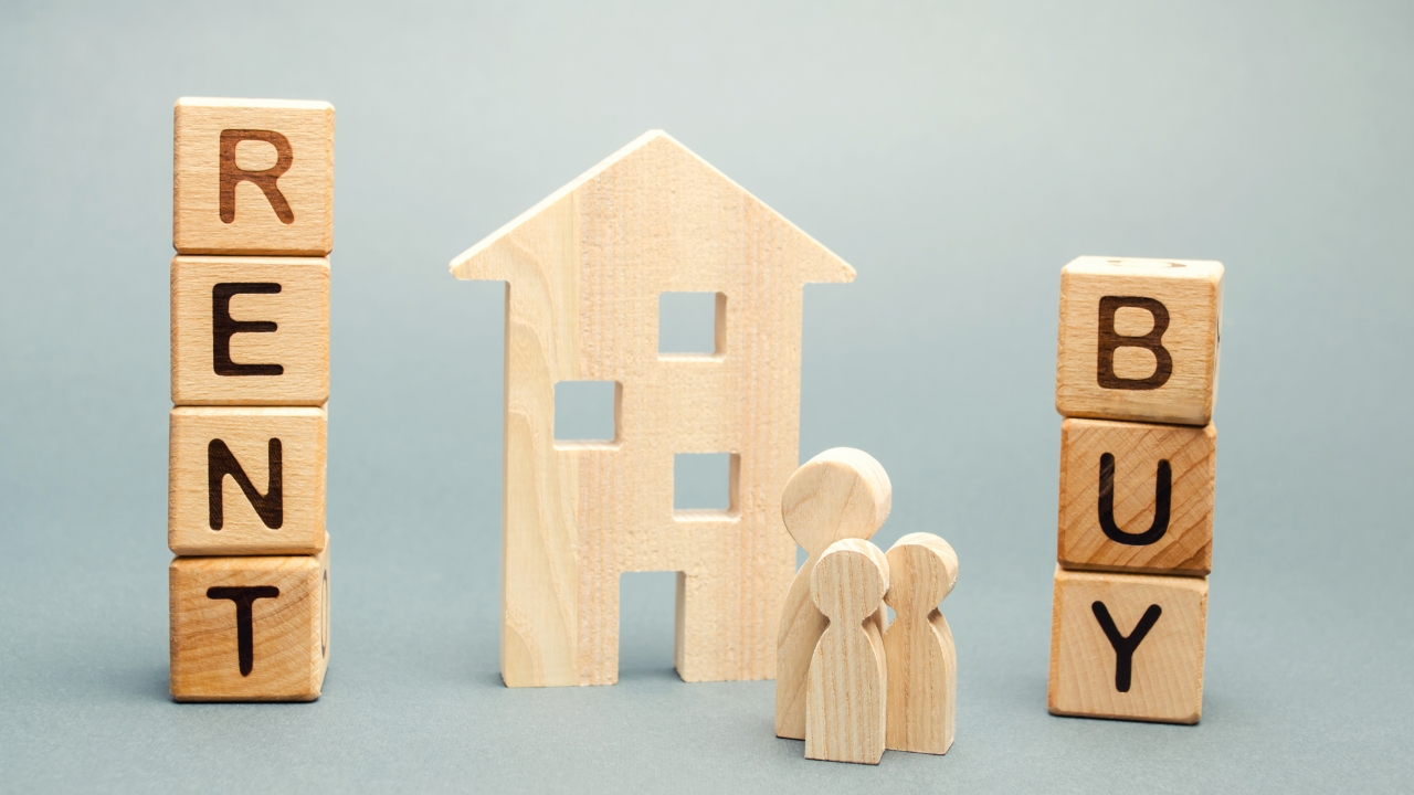 Rent and buy blocks sit beside a small house for a 2026 rent vs mortgage guide
